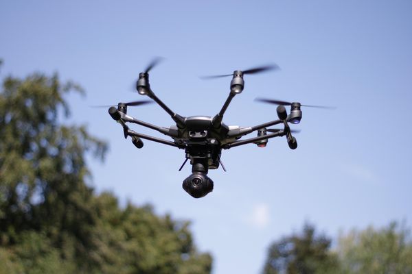 Drone flying in a blue sky